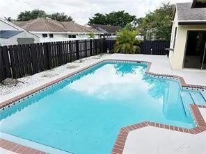 a view of a swimming pool with a patio