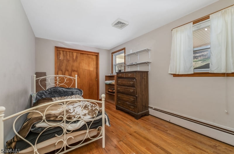 224 Bellis Road Milford, NJ 08848 - Photo 17 of 25 a bedroom with a bed and wooden floor