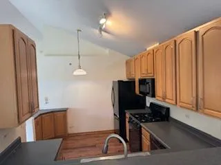 a kitchen with stainless steel appliances a refrigerator and a stove top oven