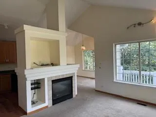 a living room with a fireplace and a window
