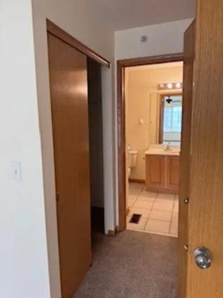 an empty room with window and bathroom