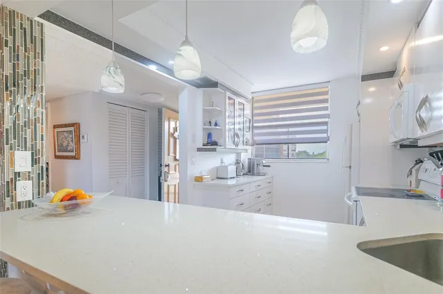 a kitchen with stainless steel appliances granite countertop a stove and a sink