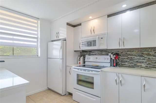 a spacious bathroom with a granite countertop sink and a mirror
