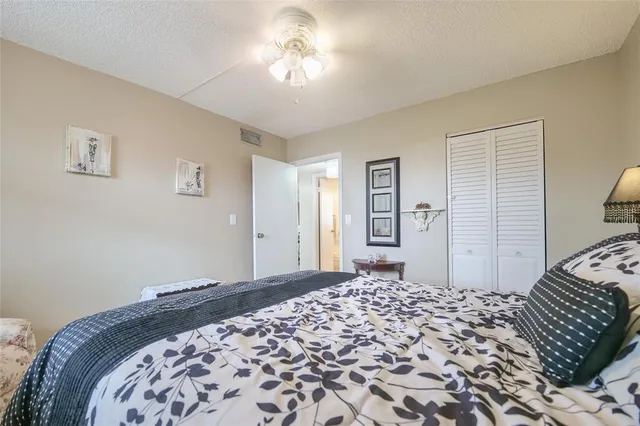 a view of swimming pool with lawn chairs and plants