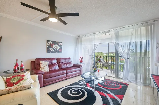 a living room with furniture a rug and a chandelier