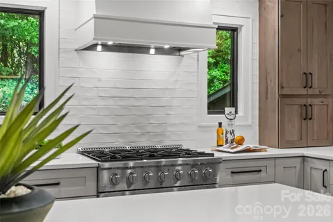 a stove top oven sitting inside of a kitchen