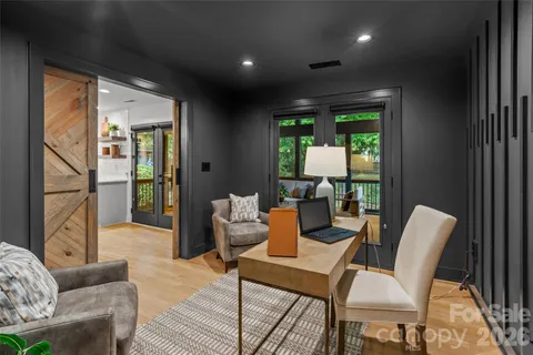 a dining room with furniture a fireplace and wooden floor