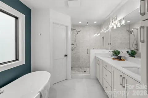 a spacious bathroom with a double vanity sink toilet and shower
