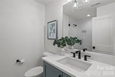 a bathroom with a sink toilet and mirror