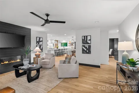 a living room with furniture and a wooden floor