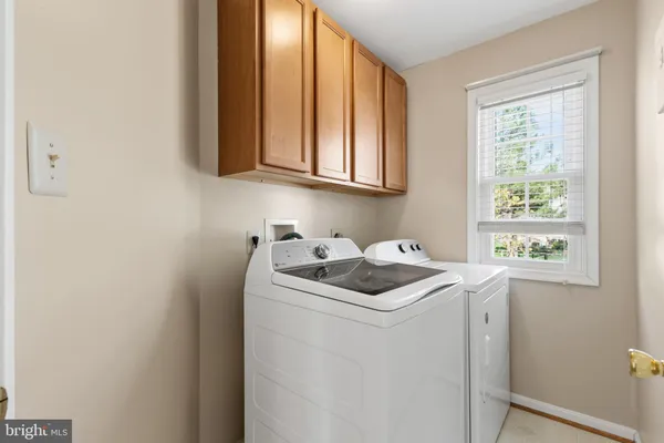 a utility room with closet dryer and washer