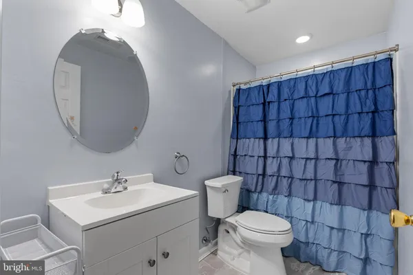 a bathroom with a toilet a sink and mirror