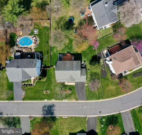 an aerial view of a house with a garden and swimming pool