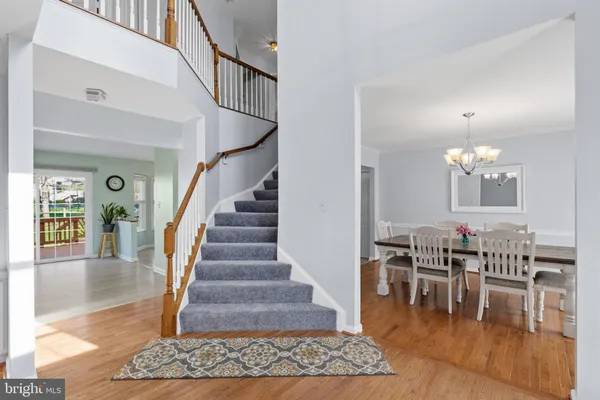 a view of entryway and dining room with wooden floor