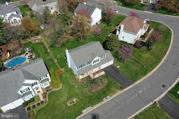 an aerial view of a house with garden space and street view