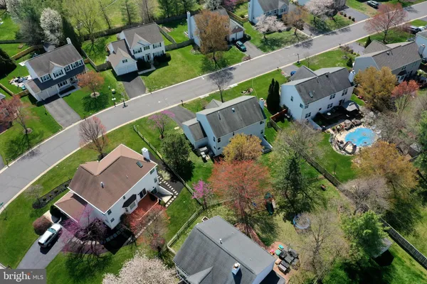an aerial view of a house with garden space and street view