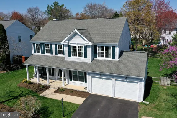 a aerial view of a house with a yard and potted plants