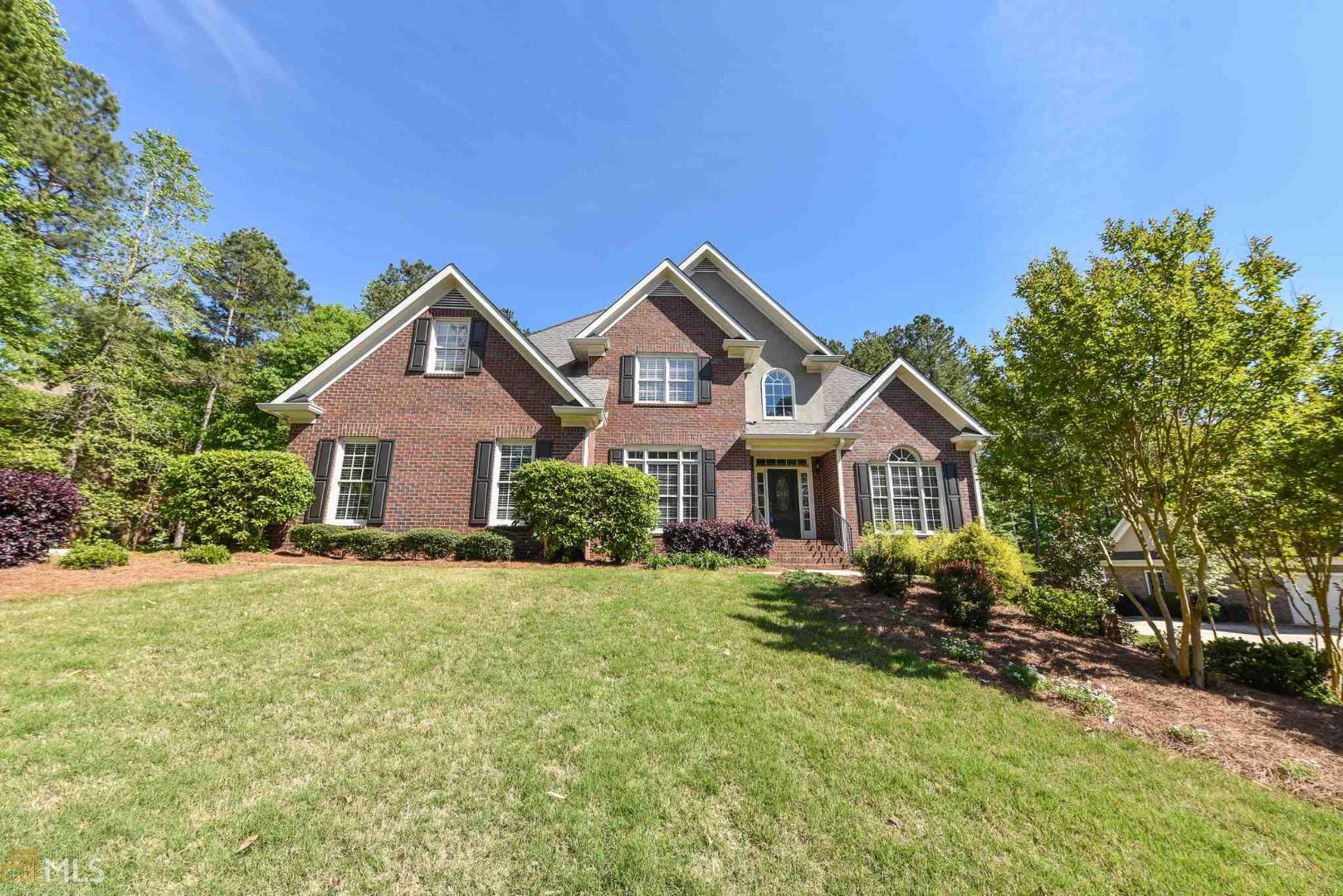 a front view of a house with a yard