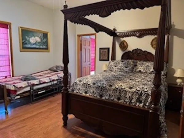 a bed room with a bed window and a chair