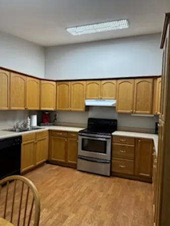 a kitchen with granite countertop white cabinets and white appliances