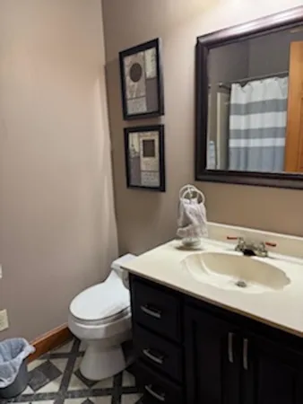 a kitchen with granite countertop a sink a stove and cabinets