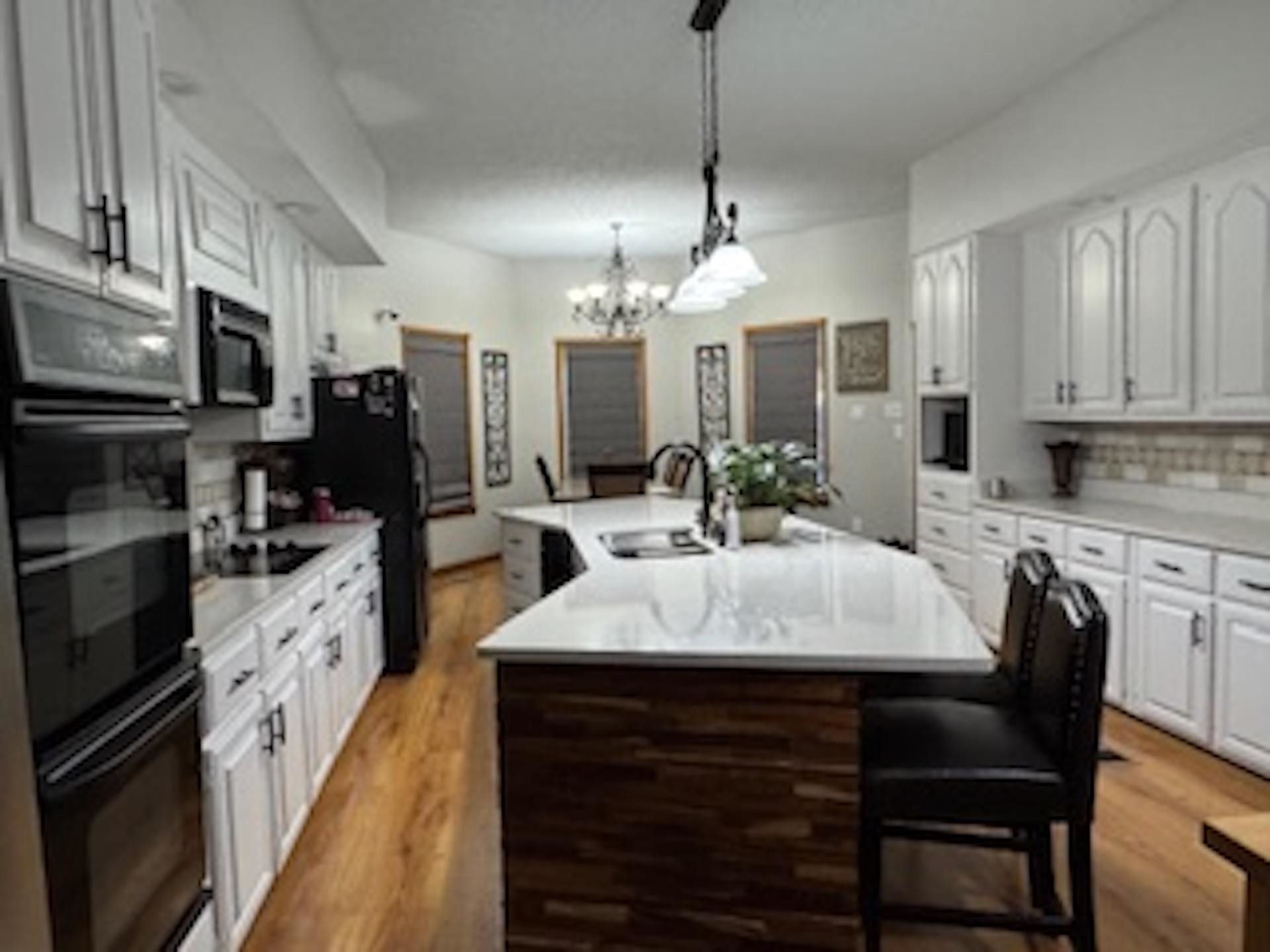 4500 New Brownsville Road Memphis, TN 38135 - Photo 4 of 23 a large kitchen with stainless steel appliances kitchen island granite countertop a table chairs and a refrigerator
