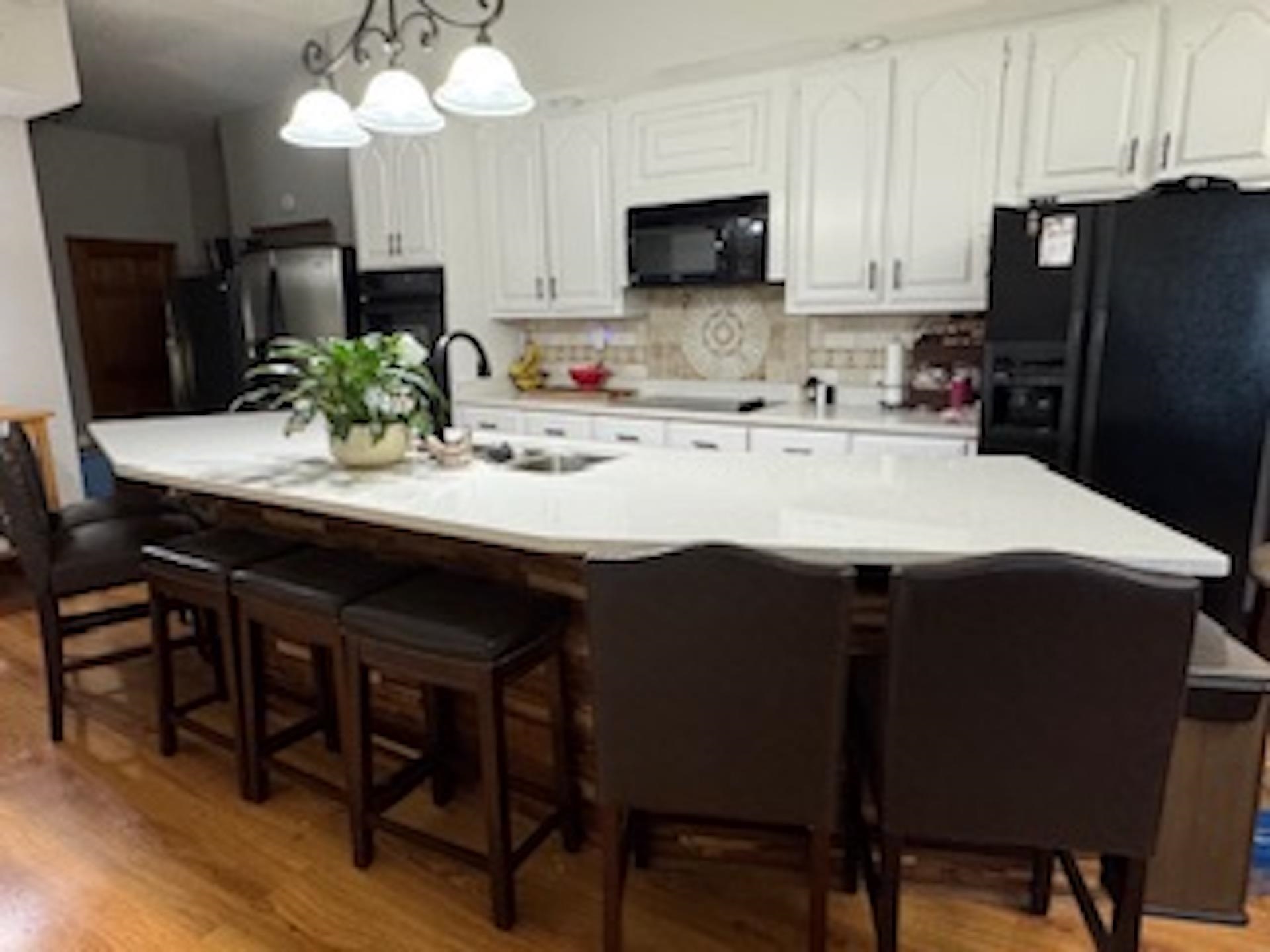 4500 New Brownsville Road Memphis, TN 38135 - Photo 5 of 23 a kitchen with a table chairs refrigerator and microwave