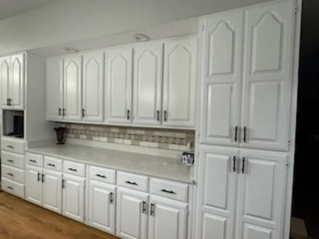 a kitchen with white cabinets and a sink