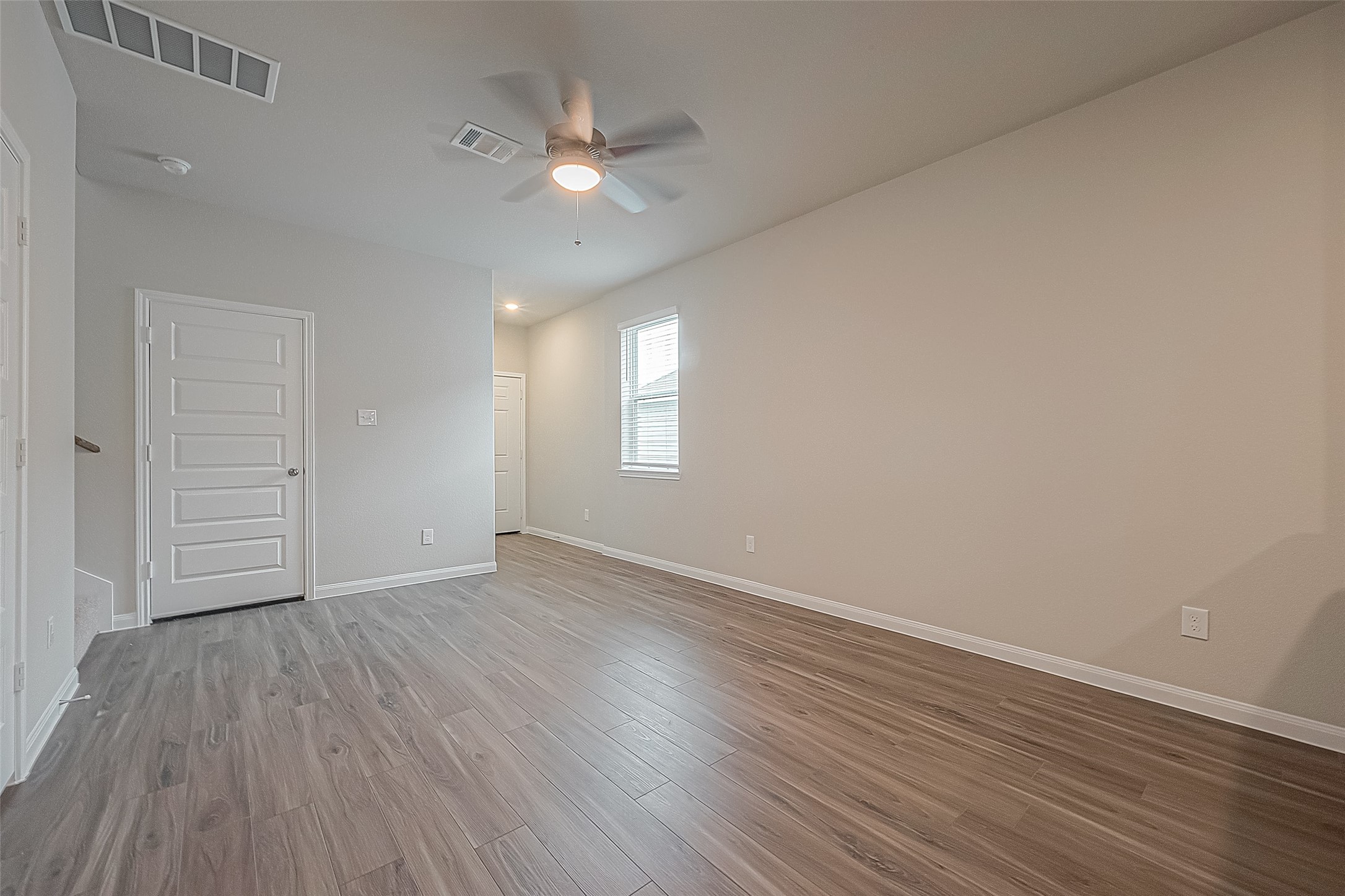 4923 Luke Matthew Drive Rosharon, TX 77583 - Photo 13 of 48 an empty room with wooden floor and window