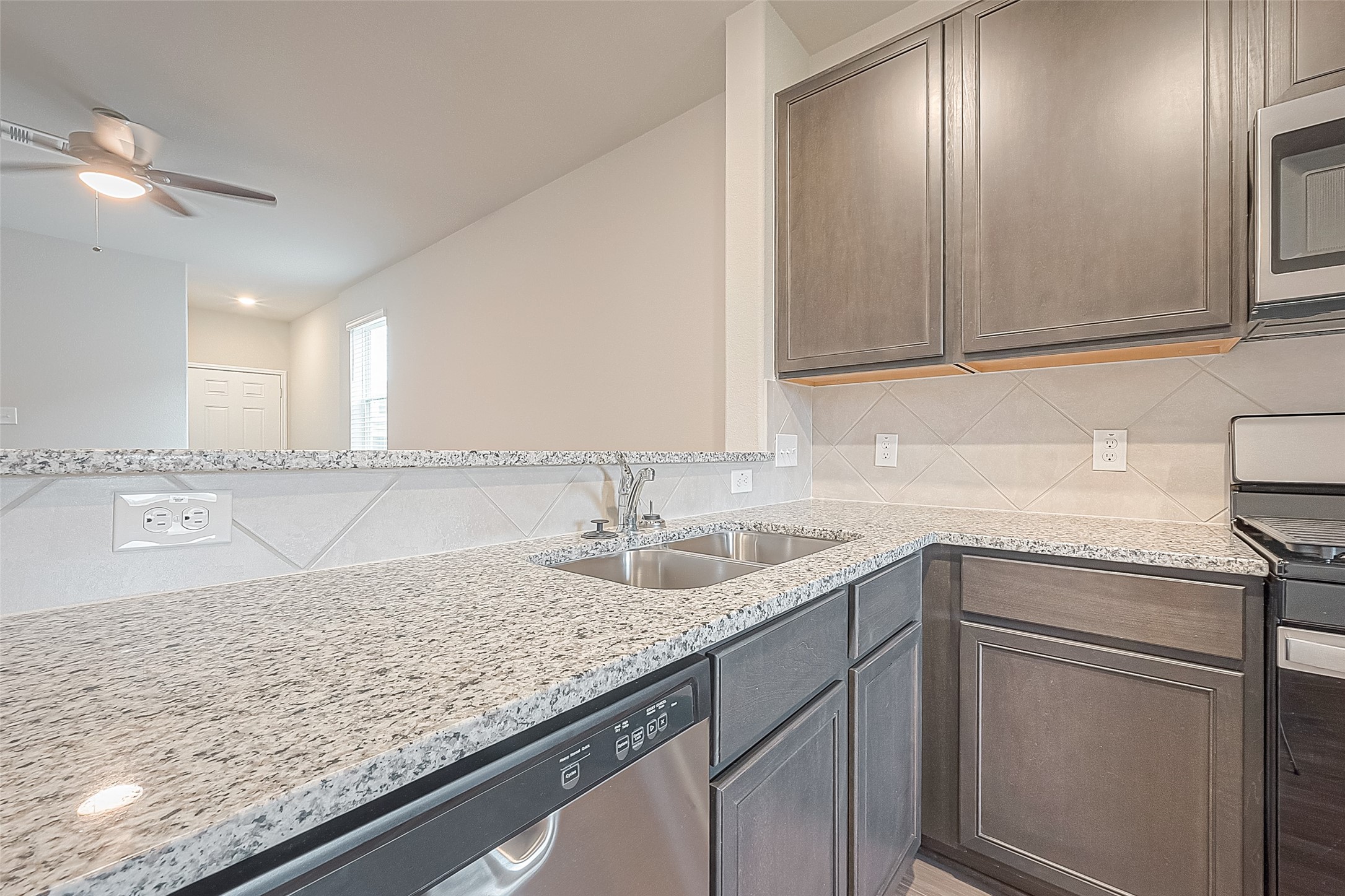 4923 Luke Matthew Drive Rosharon, TX 77583 - Photo 17 of 48 a kitchen with granite countertop stainless steel appliances sink and cabinets