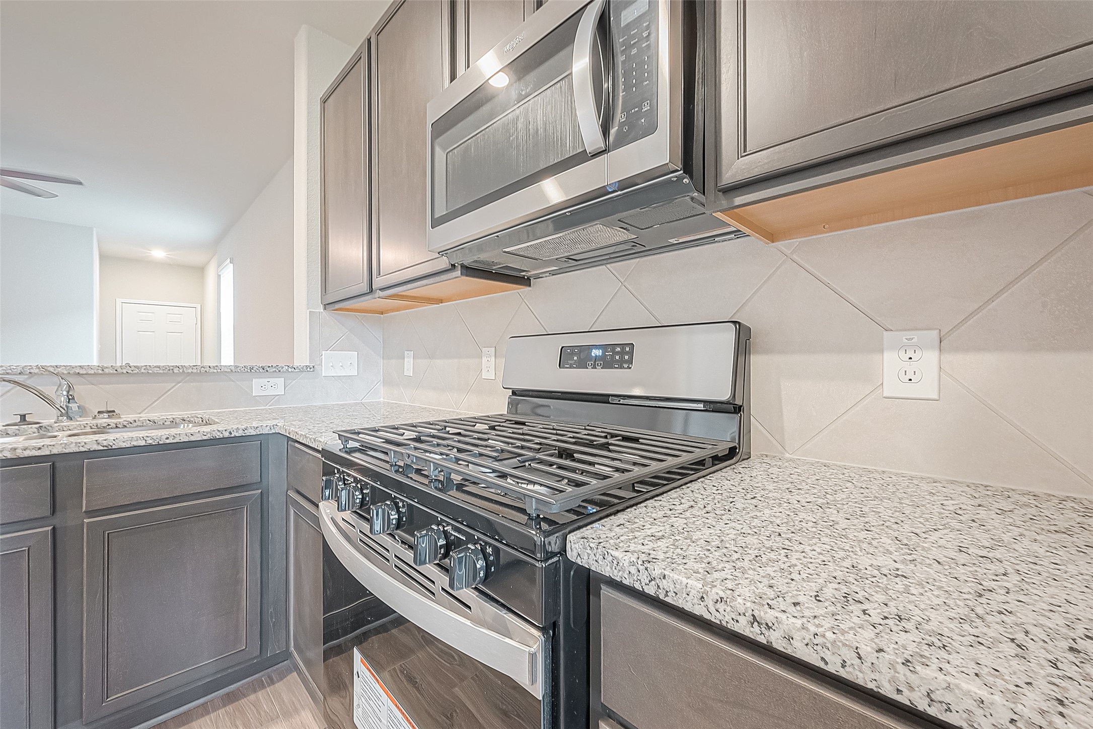 4923 Luke Matthew Drive Rosharon, TX 77583 - Photo 18 of 48 a kitchen with a stove cabinets and entryway