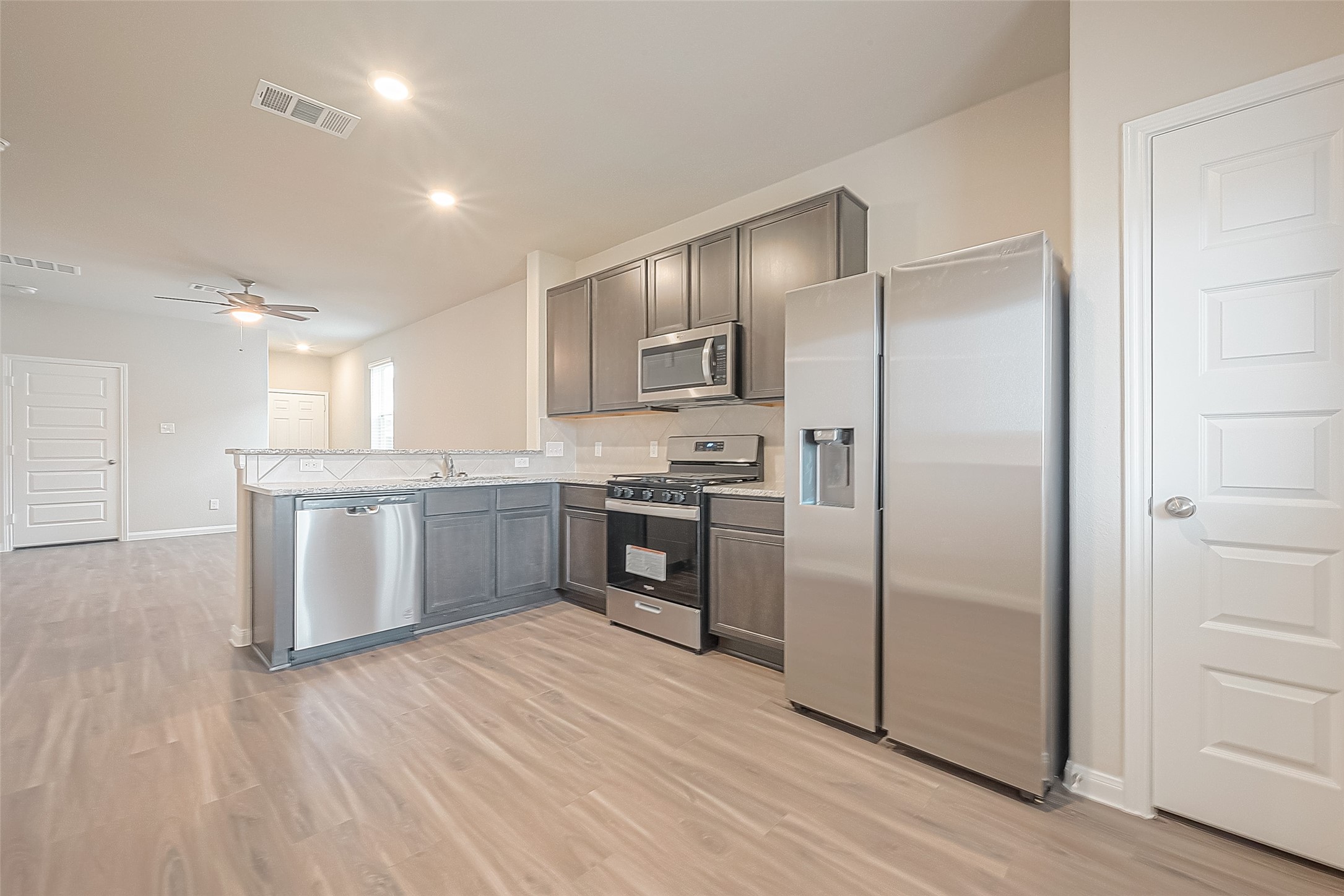 4923 Luke Matthew Drive Rosharon, TX 77583 - Photo 19 of 48 a kitchen with a refrigerator sink and cabinets