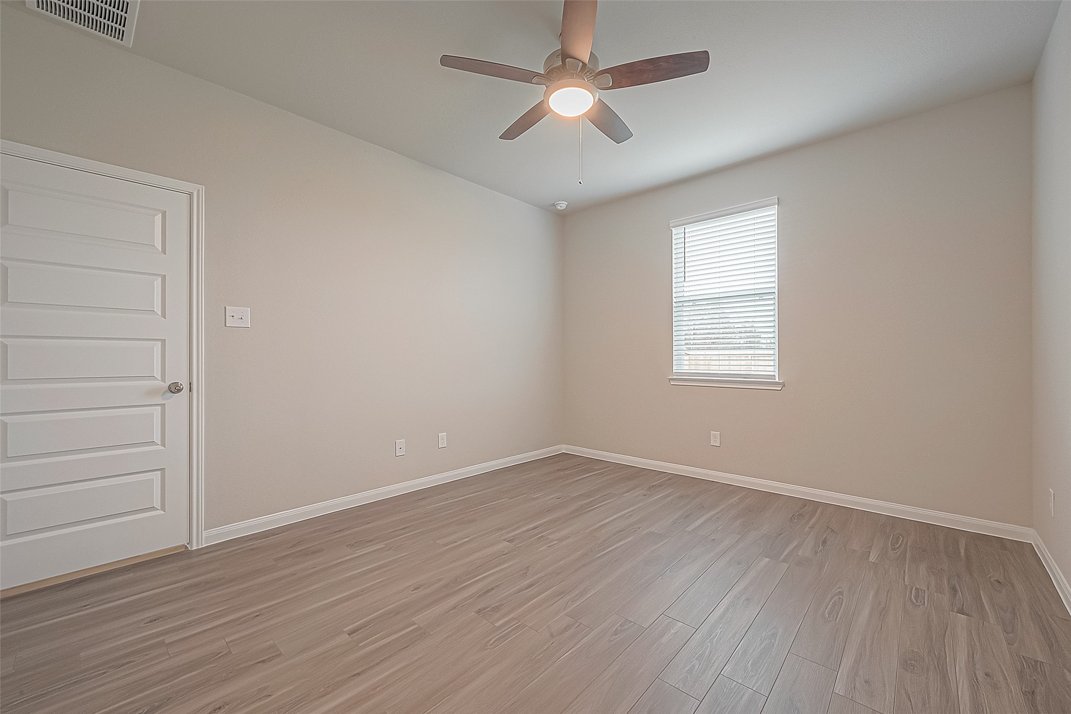 4923 Luke Matthew Drive Rosharon, TX 77583 - Photo 25 of 48 an empty room with wooden floor ceiling fan and windows