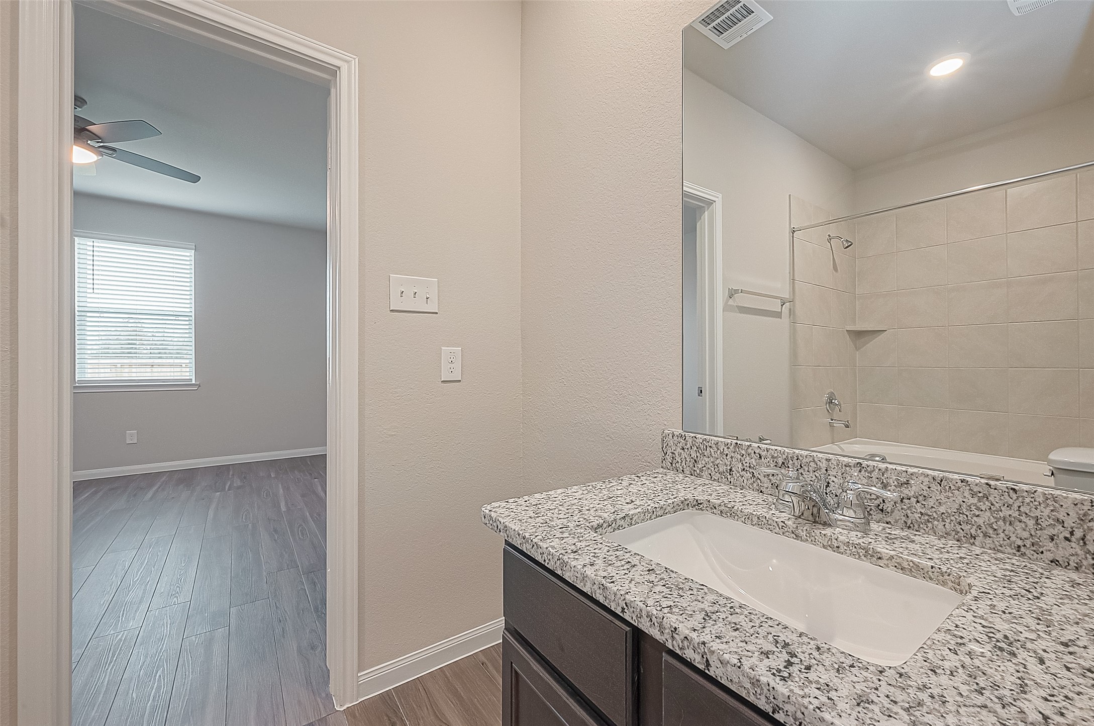 4923 Luke Matthew Drive Rosharon, TX 77583 - Photo 28 of 48 a bathroom with a granite countertop sink and a mirror