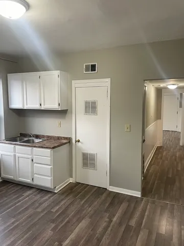 a kitchen with granite countertop a stove and a refrigerator