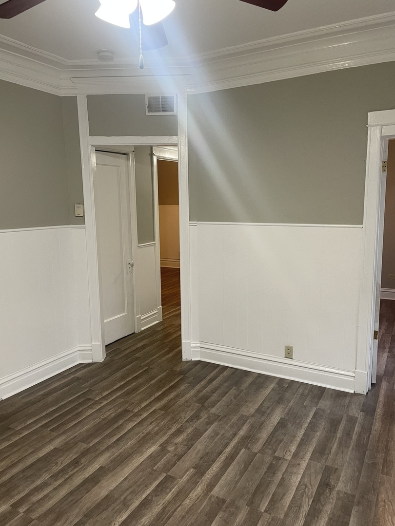 451 East 111th Street, Unit 3R Chicago, IL 60628 - Photo 7 of 7 a view of an empty room with wooden floor
