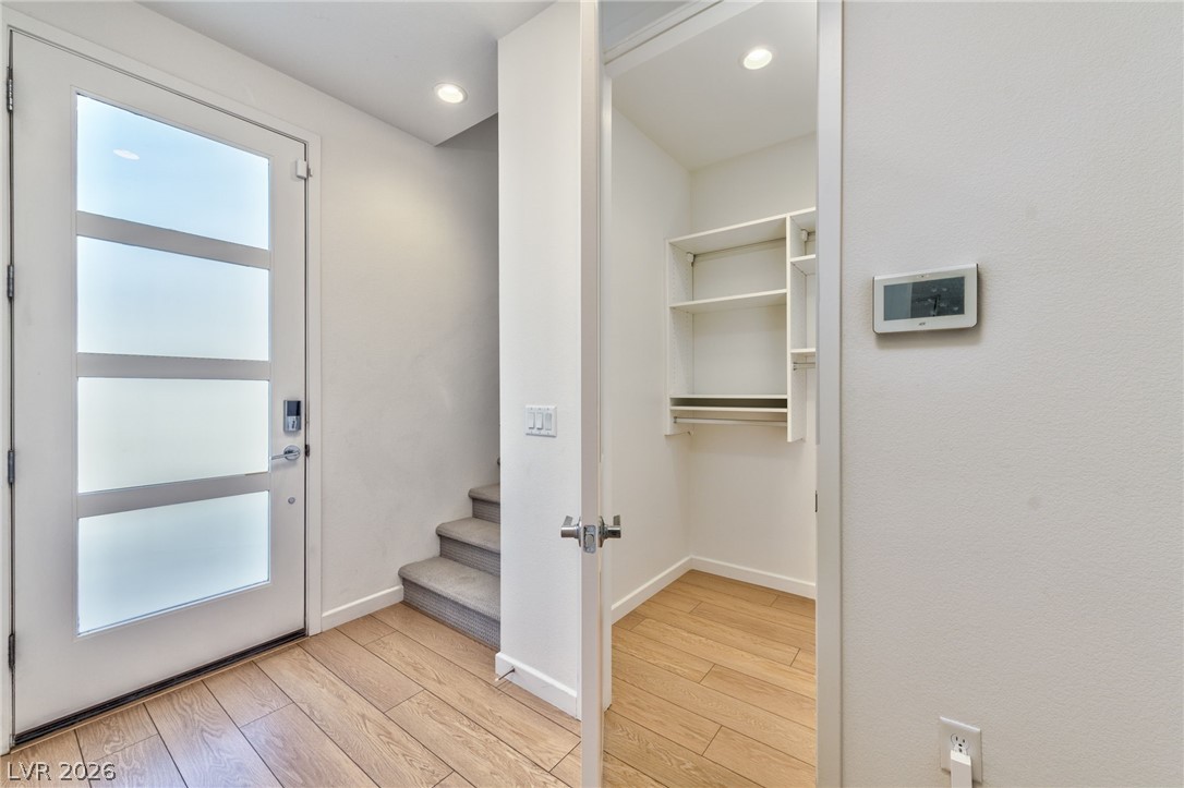 3327 Esker Rdg Avenue Henderson, NV 89044 - Photo 17 of 24 A well-lit entry welcomes with rich wood flooring and a convenient storage closet.