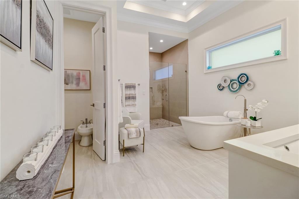 2875 Coco Lakes Drive Naples, FL 34105 - Photo 12 of 27 Bathroom featuring separate shower and tub, crown molding, sink, and a bidet