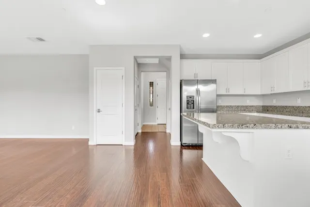a view of a kitchen with a sink and wooden floor