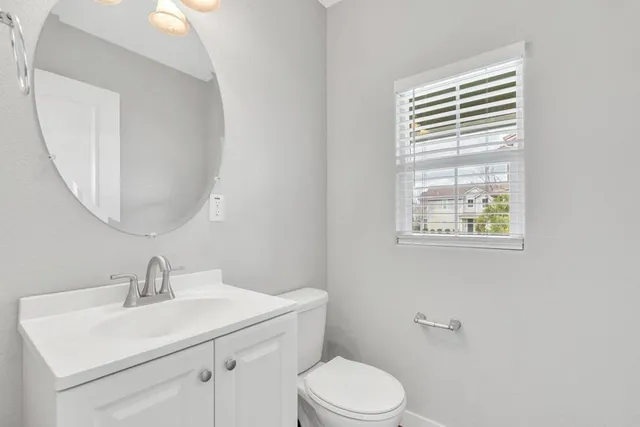 a bathroom with a sink a toilet and a mirror