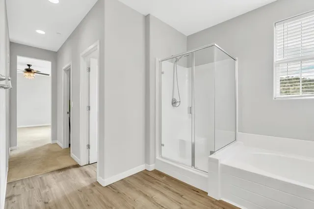 a bathroom with a bathtub and a shower