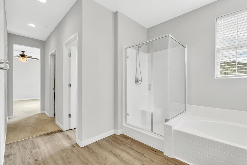 9433 Vintner Circle Patterson, CA 95363 - Photo 24 of 51 a bathroom with a bathtub and a shower