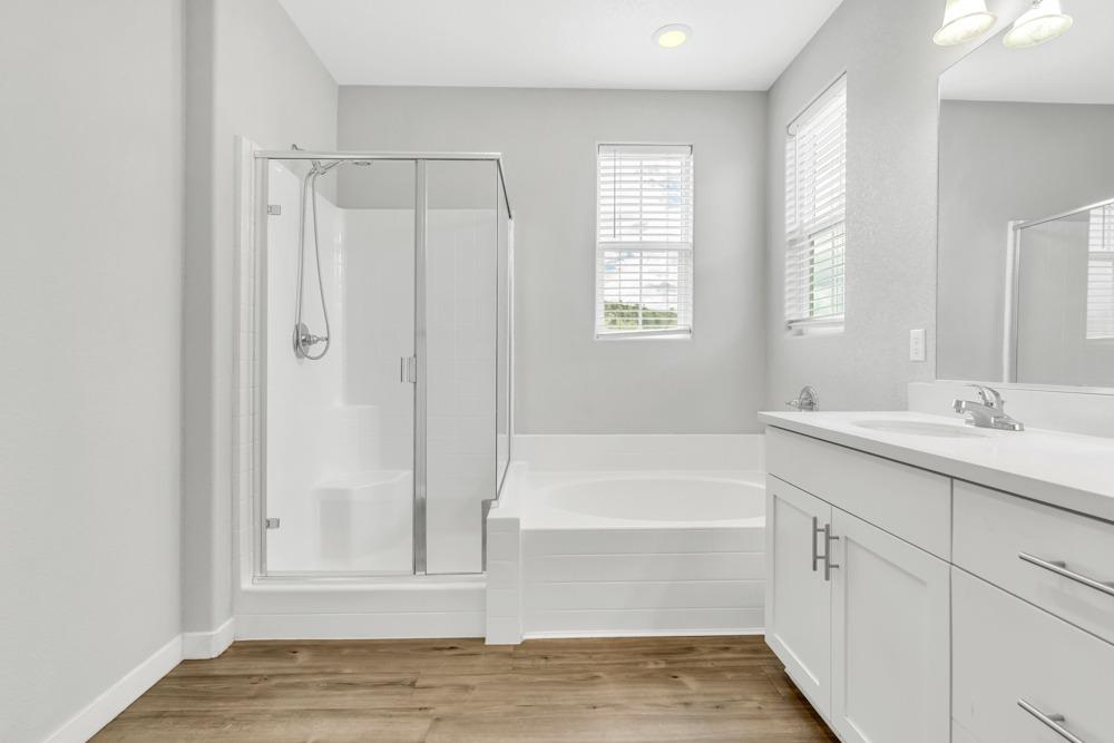9433 Vintner Circle Patterson, CA 95363 - Photo 25 of 51 a bathroom with a tub sink and mirror