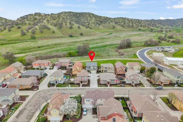 an aerial view of a residential houses with outdoor space