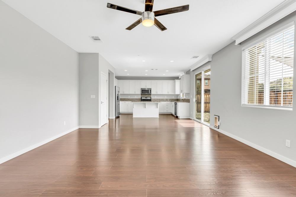9433 Vintner Circle Patterson, CA 95363 - Photo 9 of 51 a view of empty room with wooden floor and windows