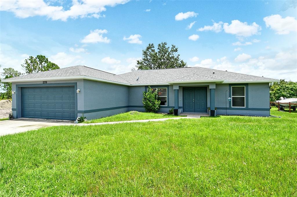 a front view of a house with a yard and garage