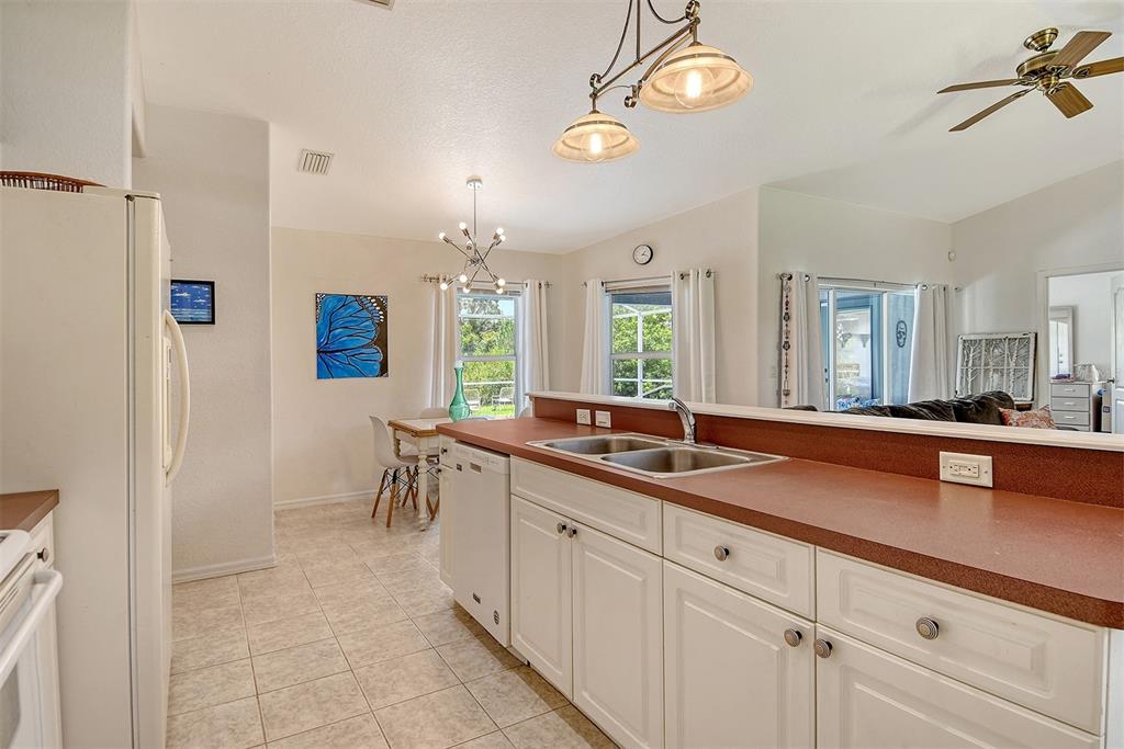 2276 Polaris Road North Port, FL 34291 - Photo 12 of 31 a spacious bathroom with a granite countertop sink a mirror and a shower
