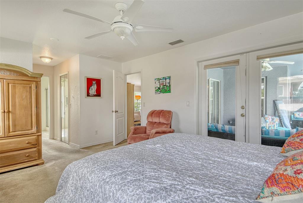 2276 Polaris Road North Port, FL 34291 - Photo 20 of 31 a bedroom with a bed and a chandelier