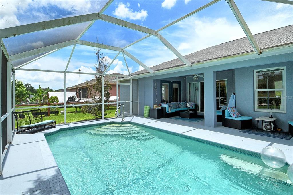 2276 Polaris Road North Port, FL 34291 - Photo 27 of 31 a view of an house with backyard porch and furniture