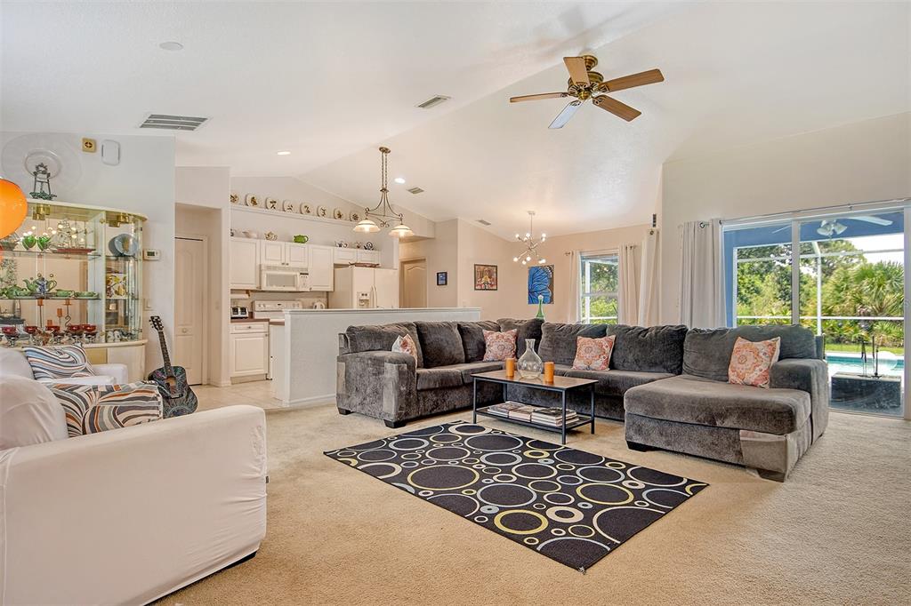 2276 Polaris Road North Port, FL 34291 - Photo 6 of 31 a living room with furniture wooden floor and a large window